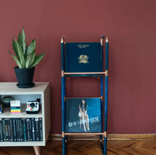 Handmade verdigris patina copper vinyl record stand with minimalist open-frame design, ideal for displaying records.