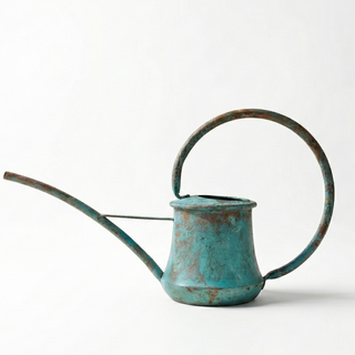 Vintage-style turquoise watering can on a white background