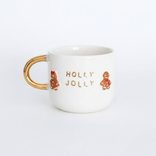 White mug with gold handle and 'Holly Jolly' text on a white background